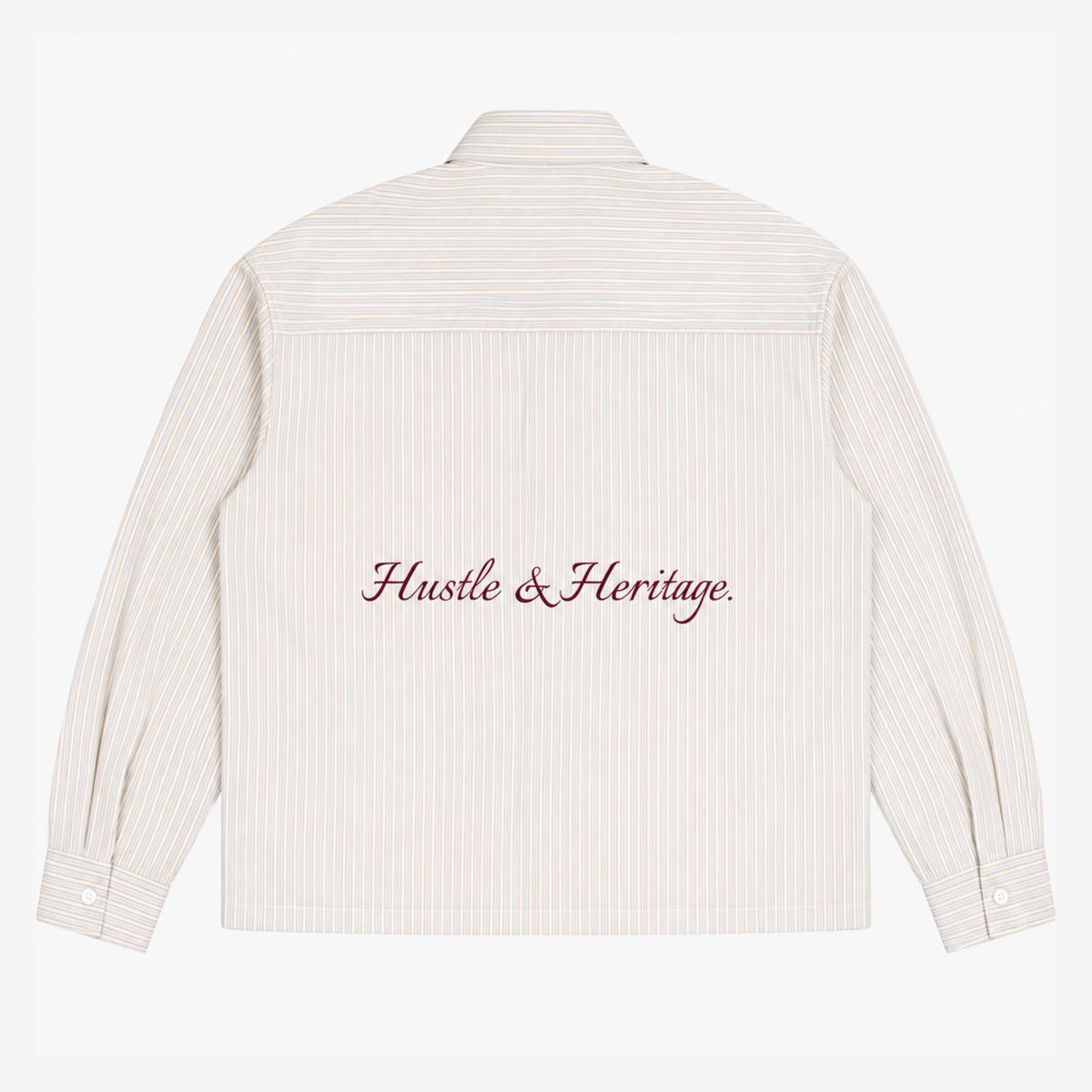 The back of a cream-colored long-sleeve shirt with thin vertical pinstripes and 'Hustle & Heritage.' embroidered in dark red script across the center.