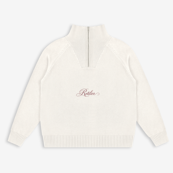 An off-white knit mock neck sweater with a center zipper and a small cursive 'Rothier' logo on the chest, displayed on a light gray background.
